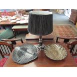 A black and silvered glass "leaf" dish and a black glass table lamp with pleated black shade and a