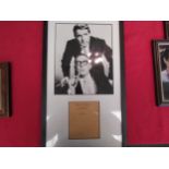 A framed and glazed photograph of Morecambe & Wise bearing signature, no provenance