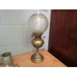 An early 20th Century brass oil lamp with Hinks No 2 safety burner, decorative globular shade