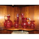 A selection of Victorian and later cranberry glass including decanter, jugs and glasses