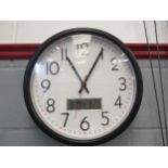 A wall clock with date, day and temperature display, 38cm diameter