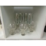 Various drinking glasses including champagne flutes, large wine and footed tumblers