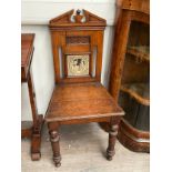 A Victorian oak hall chair, broken arch back set with Much Ado About Nothing tile, solid seat,