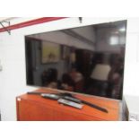 A Samsung UE40J5100AK flatscreen TV and accessories