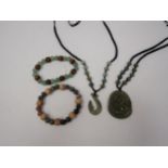 A carved jade dragon pendant, two bracelets and a necklace