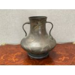 A late 19th/early 20th Century bronze vase in the Art Nouveau style, shaped handles, leaf relief,
