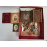 A collection of bijouterie; miniature treen tape measure, old photos, wax seal in wooden box,