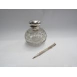A silver topped glass scent bottle, loose lid and a pencil stamped 900
