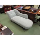 A Victorian swan back chaise long on turned legs and ceramic castors