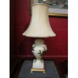 A baluster form table lamp with gilt floral decoration, with shade