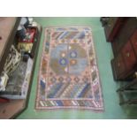 A geometric handwoven wool rug, 162cm x 97cm