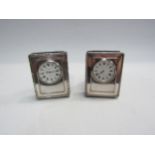 A pair of Kitney and Co. silver easel back timepieces