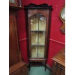 A 19th Century mahogany corner cabinet with single glazed panel door, pad feet and under tier, crack