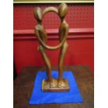 An abstract wooden sculptural figure of a couple dancing, 30cm tall