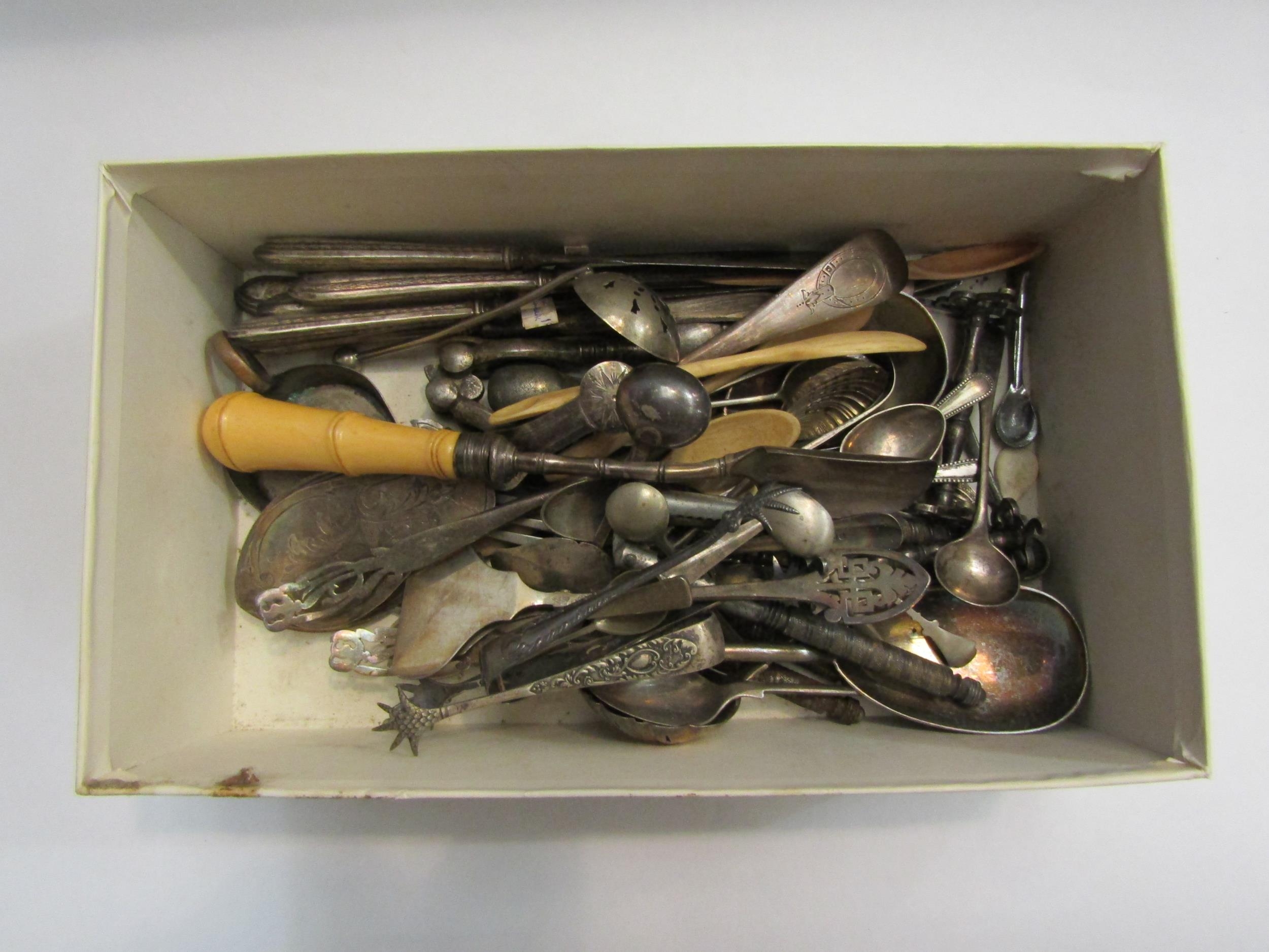 A box of plated wares including sugar tongs, scoop, salt spoons etc also bone spoons and silver