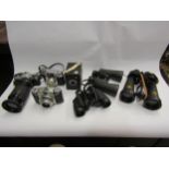 A quantity of cameras and binoculars incl Olympus OM20 SLR camera and Barr and Stroud CF41 naval