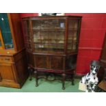 A circa 1800 revival walnut canted corver vitrine the panel glazed single door over a two door