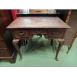 An early 1800's oak three drawer side table with carved decoration. 68cm x 75cm x 47cm