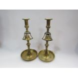 A pair of 19th Century brass tavern candlesticks with incorporated bells, 33cm tall