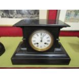 A black marble mantel clock with Paris movement, Roman numeral dial, with pendulum, no key