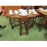 An 18th Century pegged oak gateleg table the rising leaves oval top and cutlery end drawer over