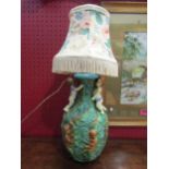 A Majolica style table lamp with pair of cherubs climbing, a/f