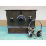 A Beltona three valve battery radio in oak case with Beltona Trade Mark label to top of cabinet