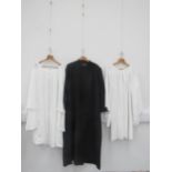 A Church of England vicars outfit including black cassock, surpluses, two shirts, vicar's bibs,