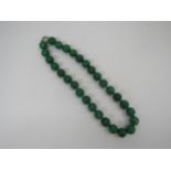 A hand knotted Jade necklace, 14mm beads