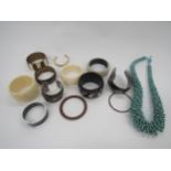 A box of vintage fashion bangles, including designer and graduated beaded loop necklace