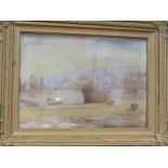 A watercolour depicting moored sailing vessels at low tide, colours faded, gilt framed and glazed,