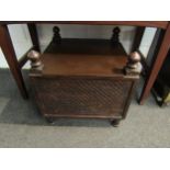 A carved wood storage box with finial detail containing a framed bygone photograph of horse and cart