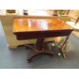 An early 19th Century mahogany folding tea table on a panelled column and concave rectangular