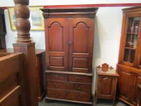 An early to mid 18th Century oak slim two door cupboard over two over two drawer base with swan neck