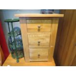 An oak three drawer bedside chest. 77cm high x 54cm wide x 36cm deep