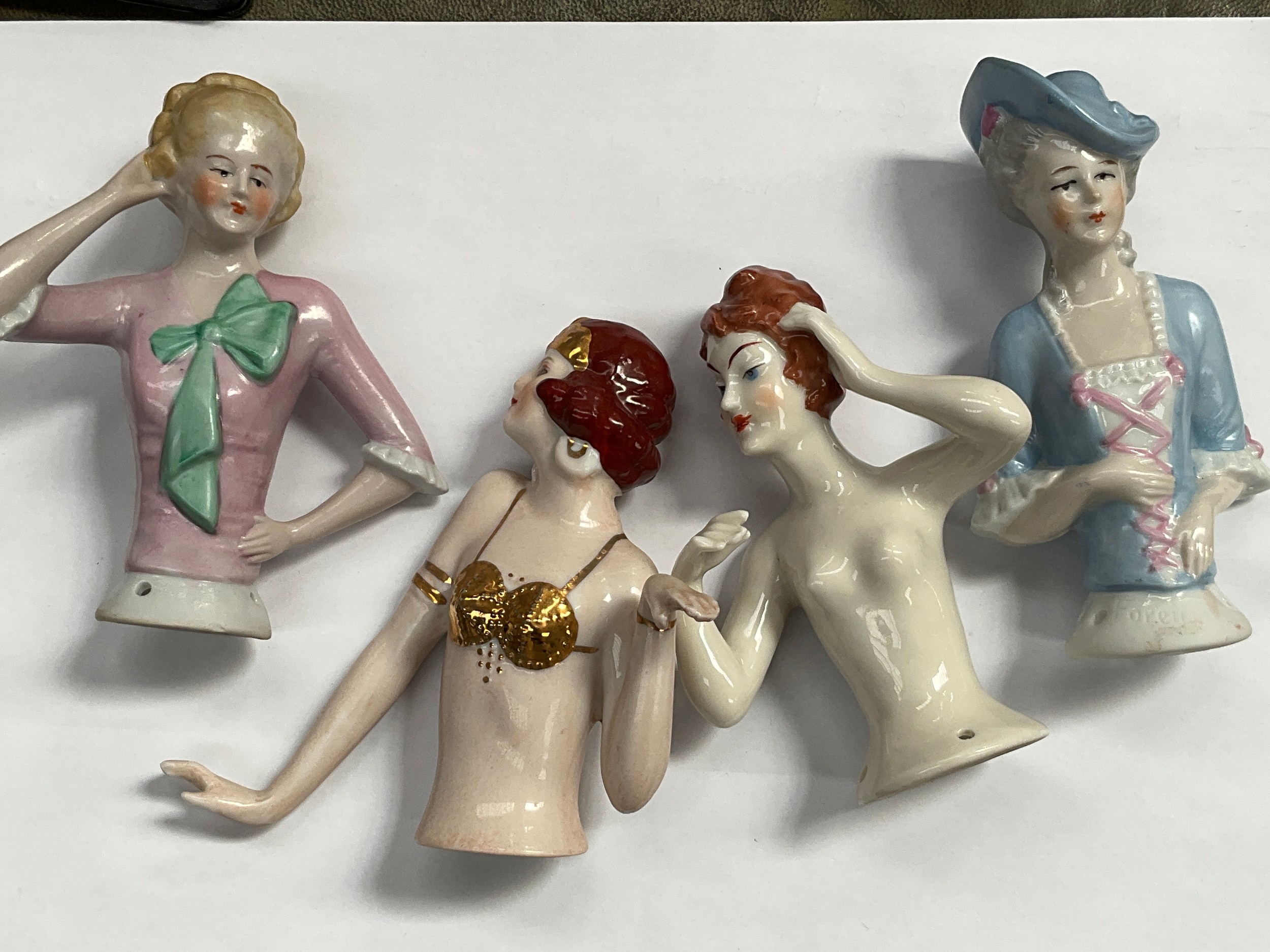 Four early 20th Century glazed china half dolls including flapper