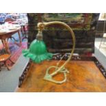A Christopher Wray 1970's lamp with brass effect and green glass frlled shade, 34cm tall