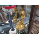 A cast metal gilt effect figure of lady with dog and a metal figure of a ballerina