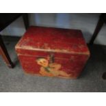 A red painted wooden box, decorated with a small child and a rodent. 46 x 32 x 31cm