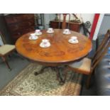 A Victorian mahogany circular breakfast table with scalloped apron and ornate column to a carved