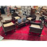 An early 20th Century Chinese rosewood lounge suite consisting of four heavily carved armchairs