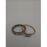 A 9ct gold ring set with white gemstones in V formation and a white gold and silver eternity ring (