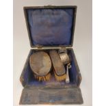 A box containing silver and sterling items; brushes, napkin rings, spoons, etc