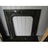 A highly decorative cast iron fire surround