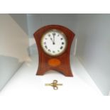 An Edwardian mahogany inlaid mantel clock. Roman numerated dial. With key. 21cm high