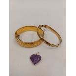 A 1/5 9ct gold bangle with metal core, another rolled gold bangle and heart pendant marked 950 set