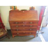 A George III mahogany bureau with four graduating maple drawers and pigeon hole interior, green