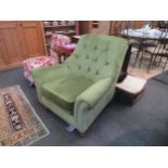 A modern 1960's style green velour button-back armchair on turned front legs