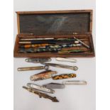 A collection of pens, pencils and pen knives