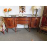 An Edwardian crossbanded mahogany serpentine fronted sideboard in the 18th Century style (back